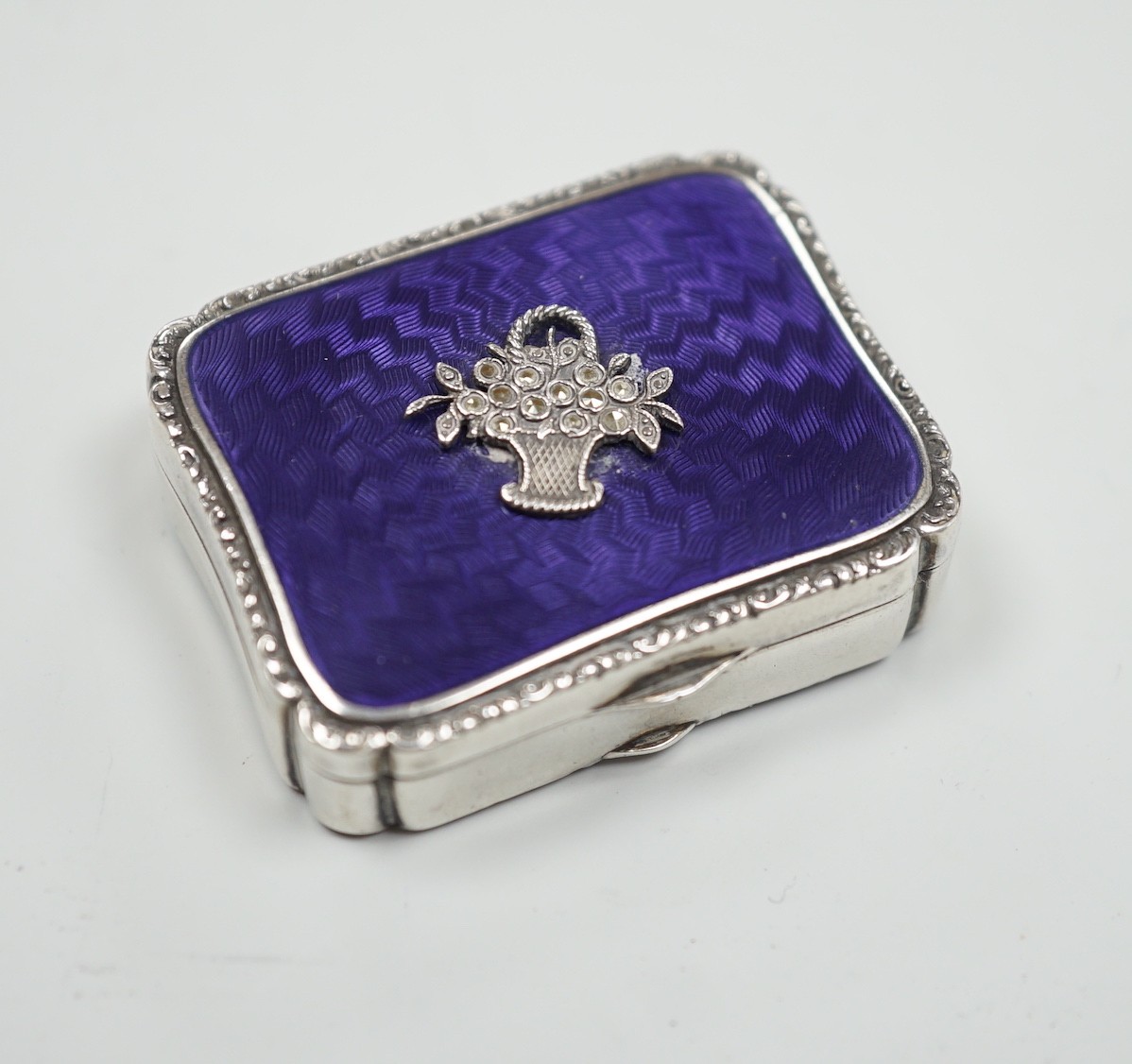 A lady's 1920's continental silver, enamel and marcasite set rouge box, import marks for London, 1925, 39mm.